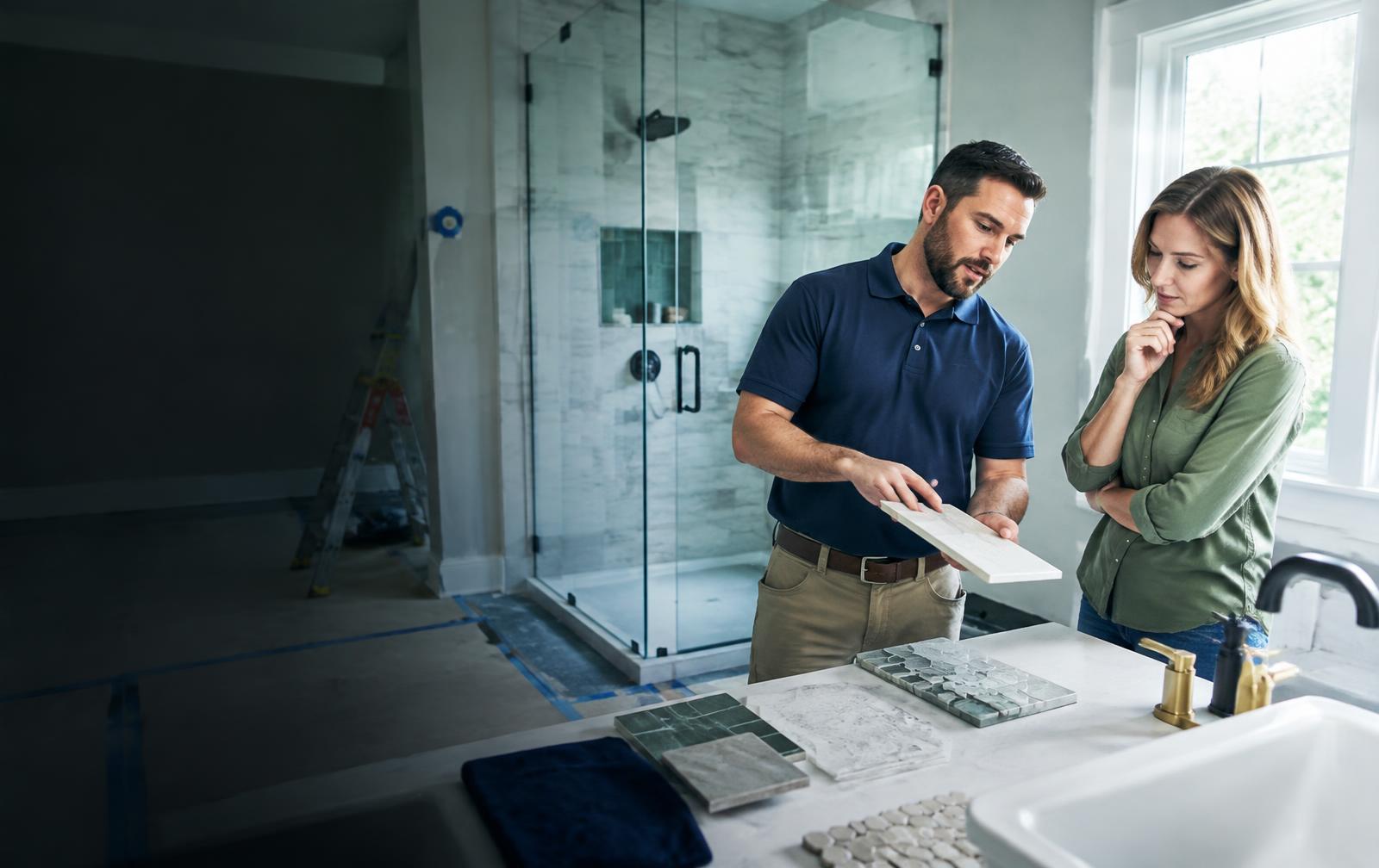 Bathroom remodeling specialist reviewing tile and fixture selections